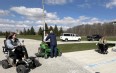 Attendees of the AT Expo learning to drive motorized wheelchairs and a zero-turn mower